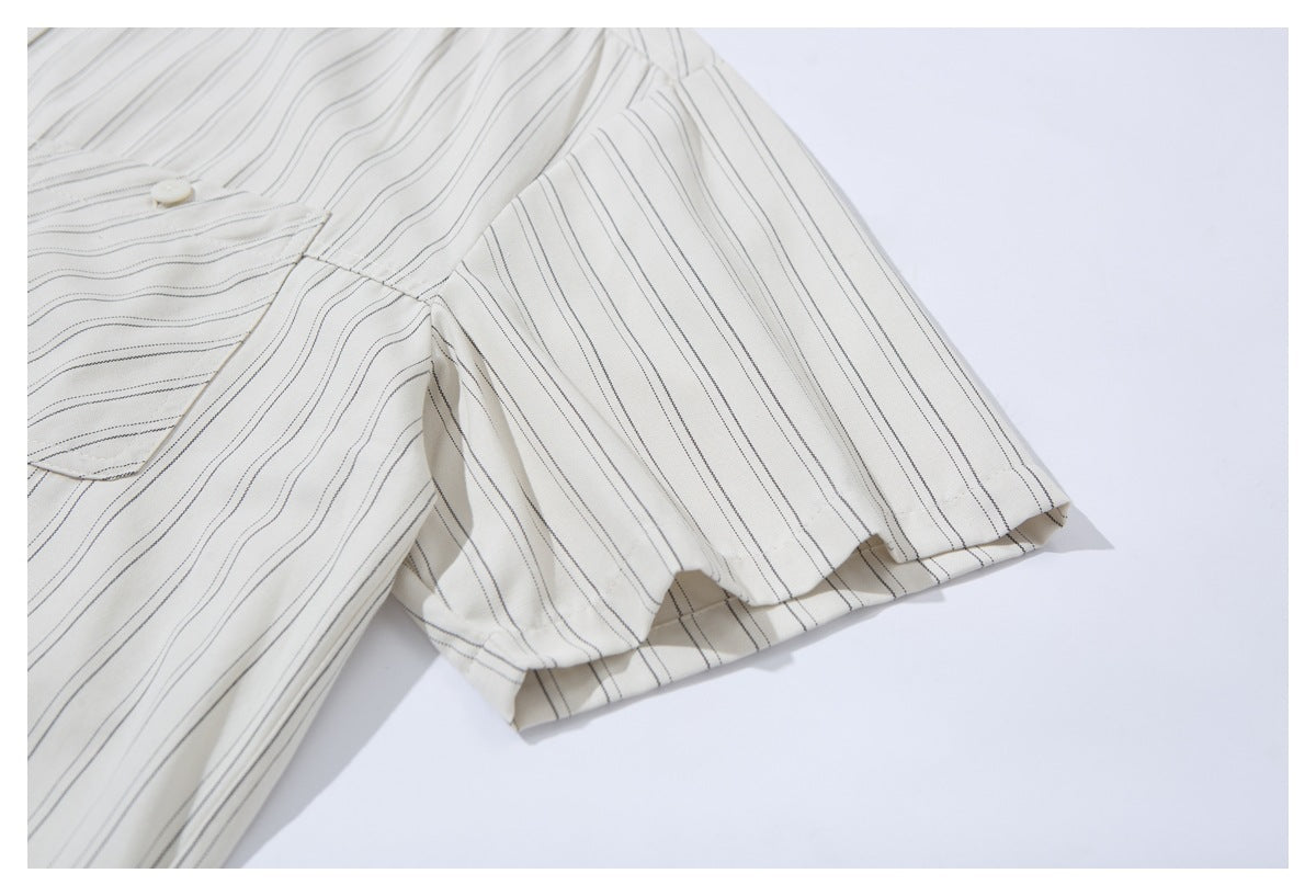 Close-up of a short sleeve on an off-white shirt with fine dark pinstripes.