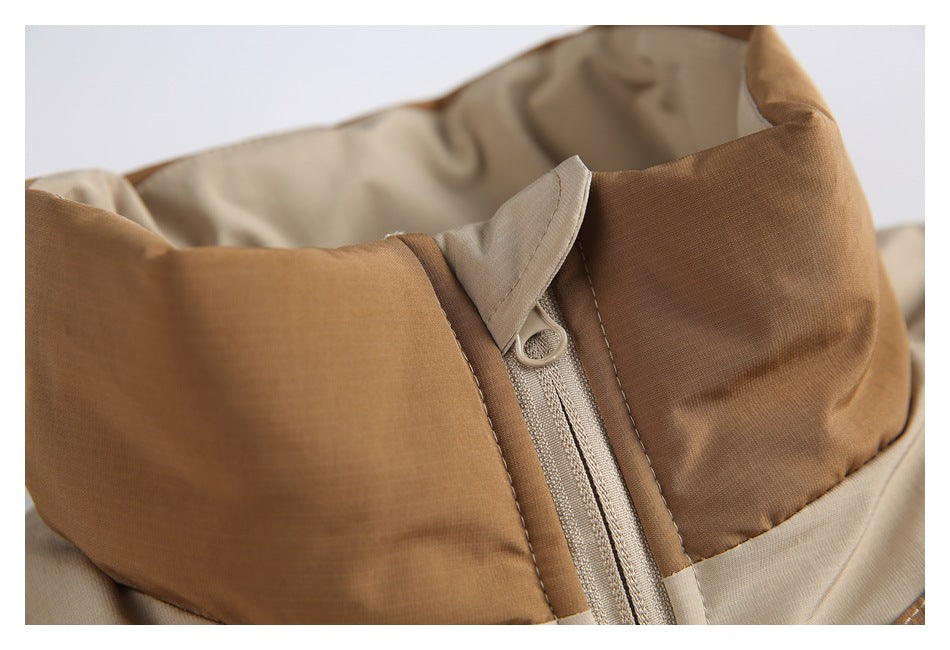 Close-up of the jacket's brown stand collar and beige front zipper with a fabric zipper guard.