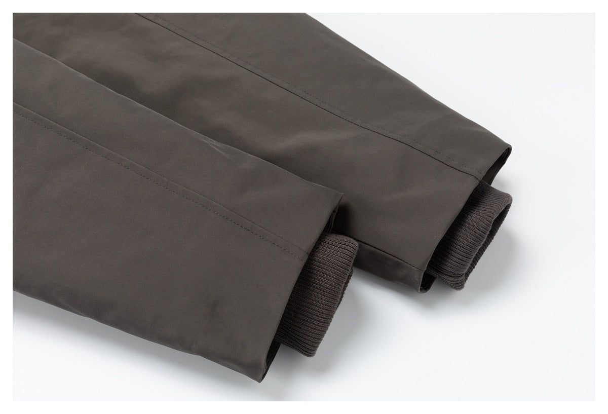 Close-up of the jacket's dark charcoal-brown sleeves and ribbed knit cuffs.