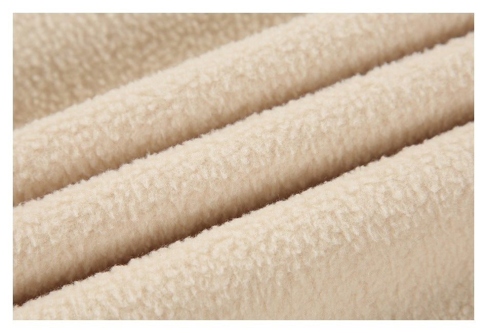 Close-up showing the thick, nubby surface of cream-colored fabric.