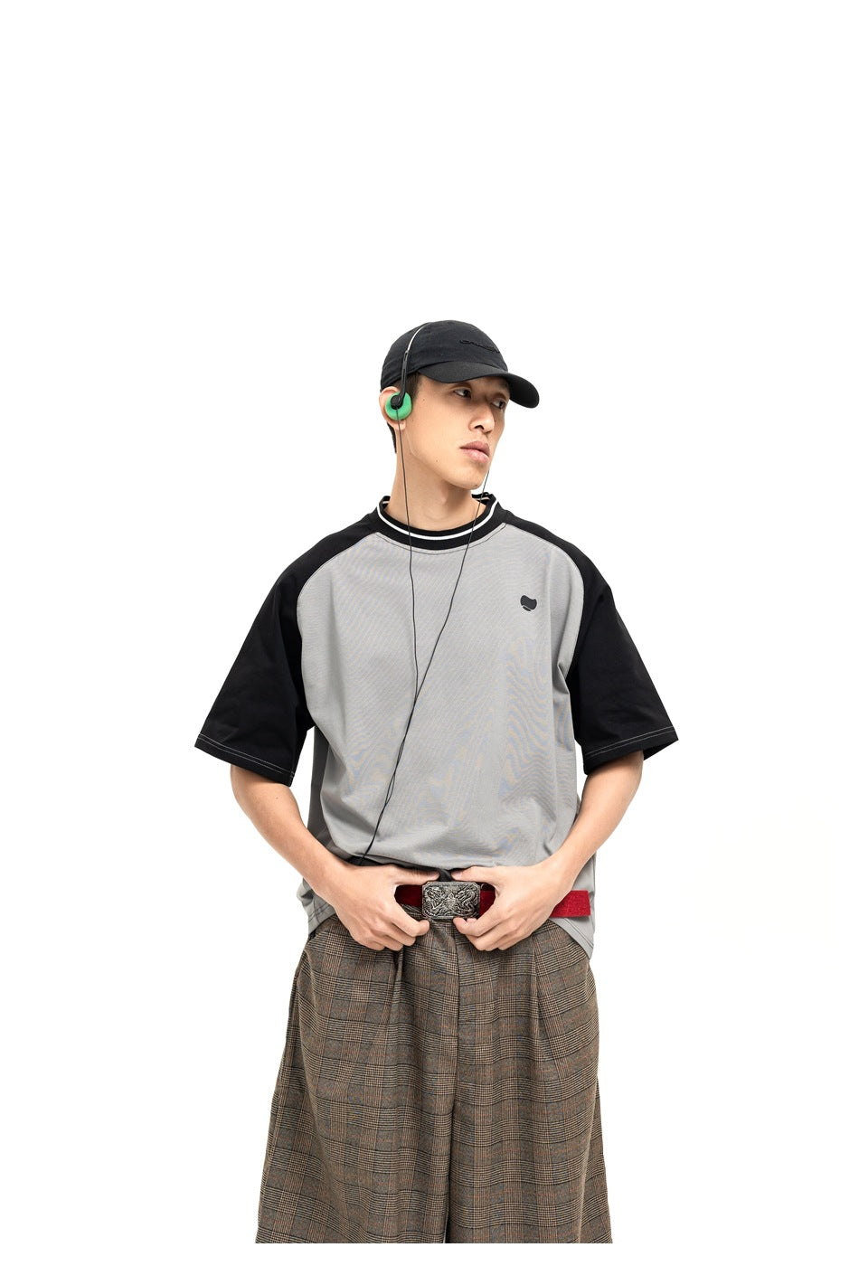 Model wearing a gray raglan T-shirt with black sleeves and a striped collar, shown from the front.