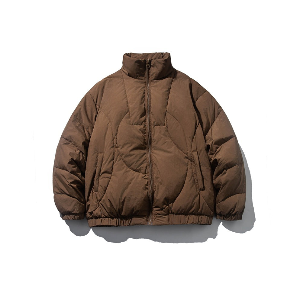 Brown quilted puffer jacket with stand collar, front zipper, side pockets and elastic cuffs, flat lay front view