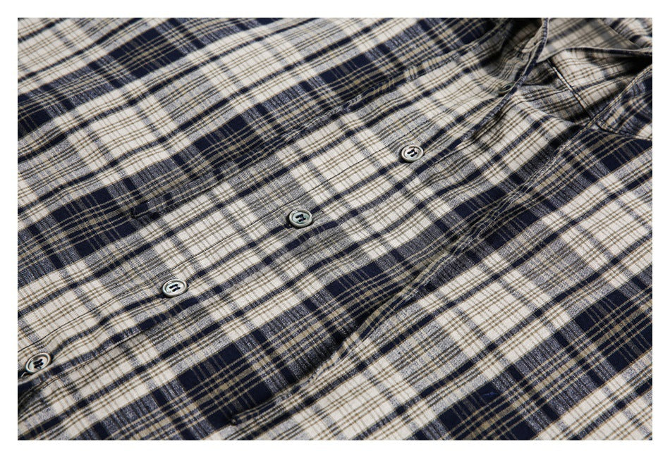 Close-up of the jacket's plaid front, showing buttons and a small welt pocket.