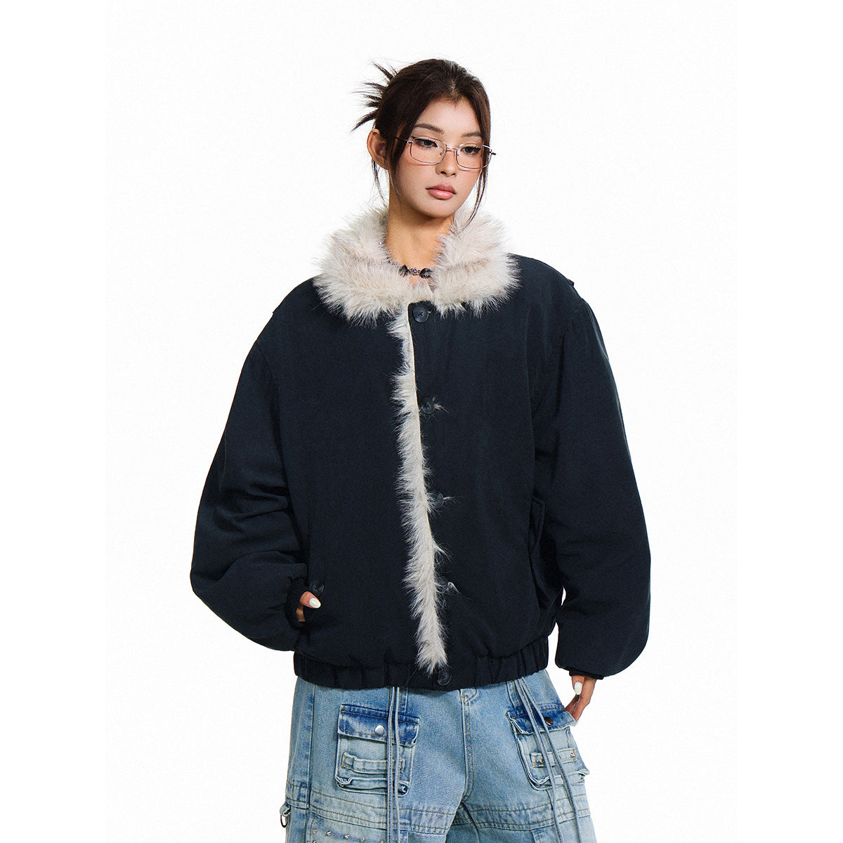 Model wearing a black jacket with a fluffy cream collar and front trim, paired with light blue cargo jeans.
