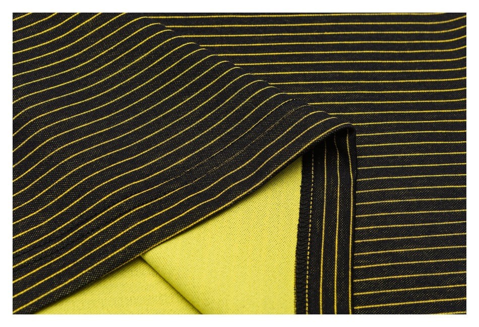Close-up of a black striped garment seam with the bright yellow reverse fabric visible beneath the fold.