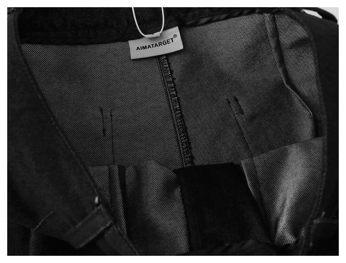 Inside view of black trousers showing the lining and an AIMATARGET label.