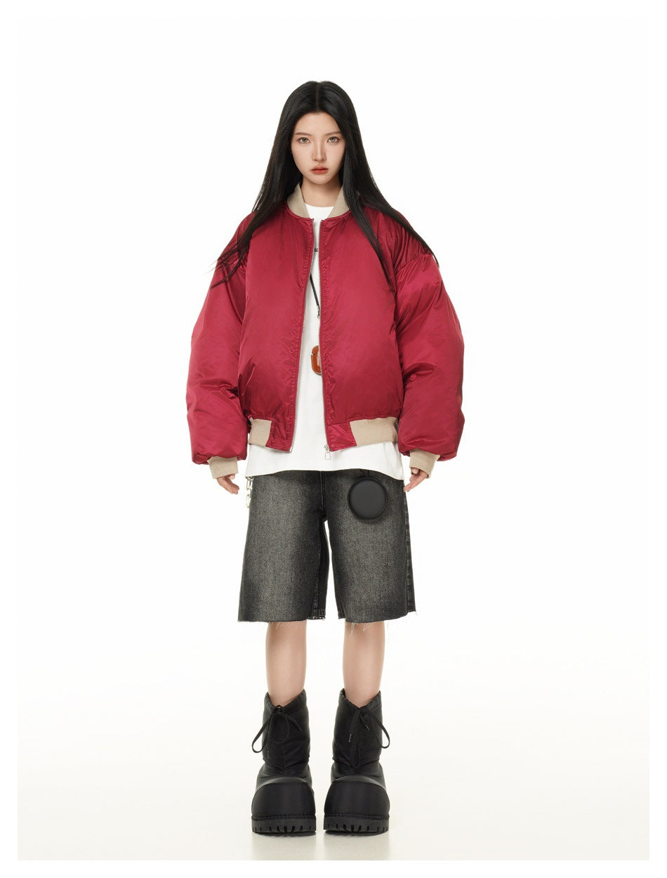 Full-length front view of a model wearing a red oversized jacket with beige ribbed trim.