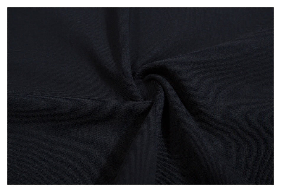 Close-up of black fabric gathered into a twist, showing its fine texture.