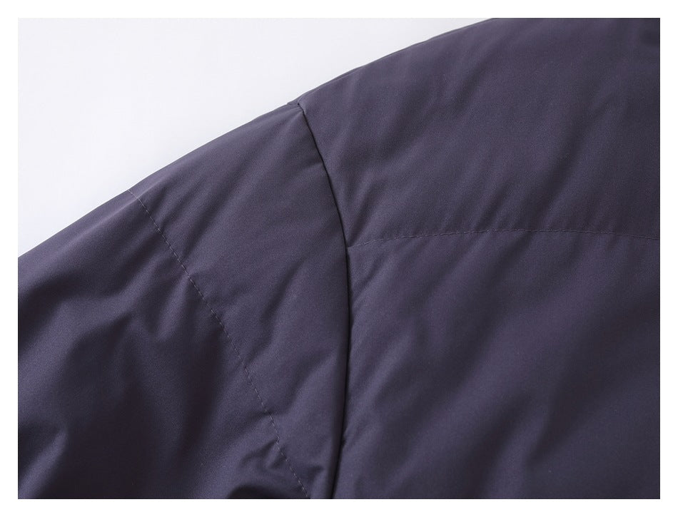 Close-up of the dark navy jacket's shoulder and sleeve seam stitching.