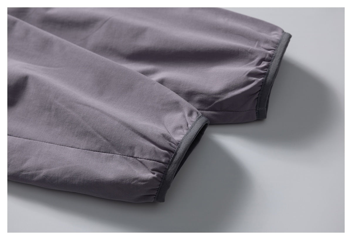 Close-up of the purple jacket sleeves with gathered cuffs and dark trim.