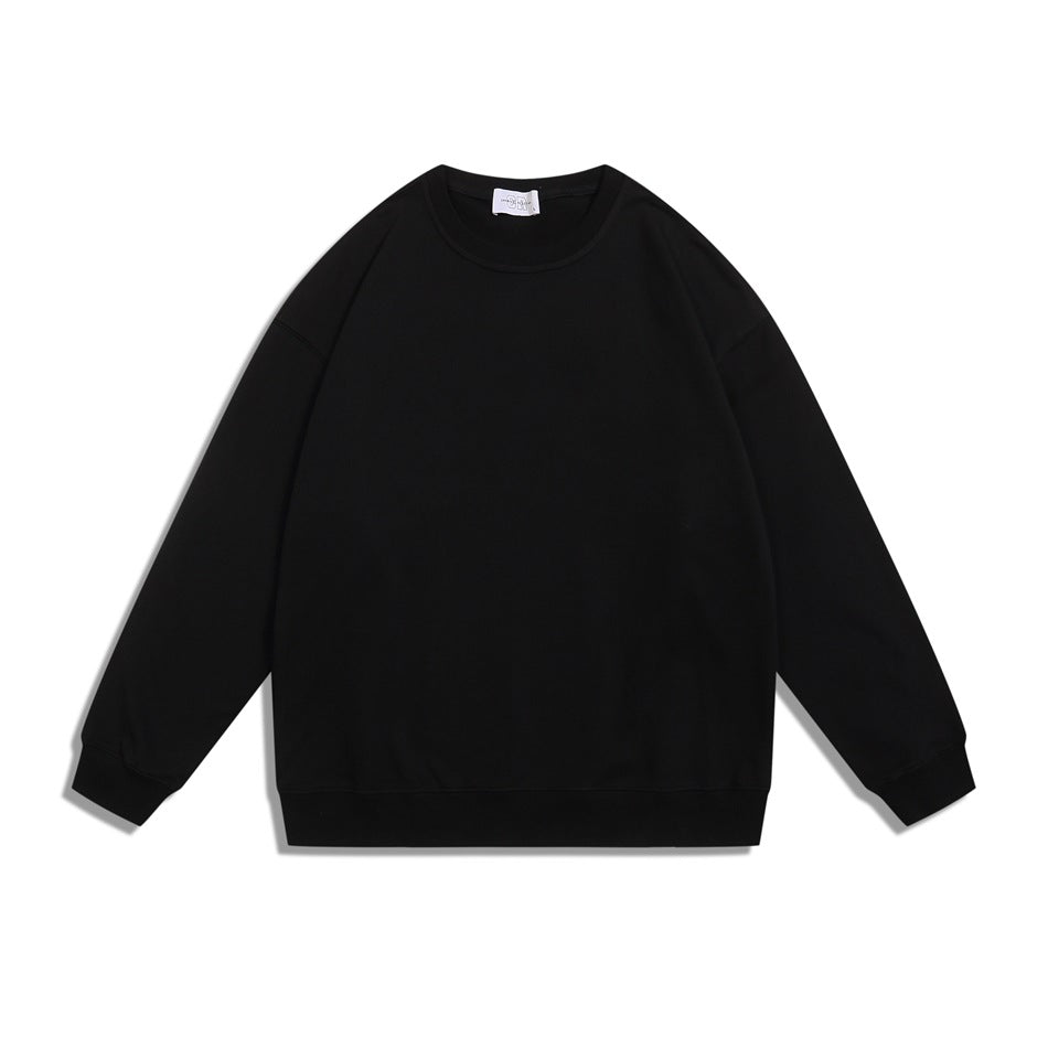 Black crewneck sweatshirt flat lay, front view, with ribbed collar, cuffs and hem
