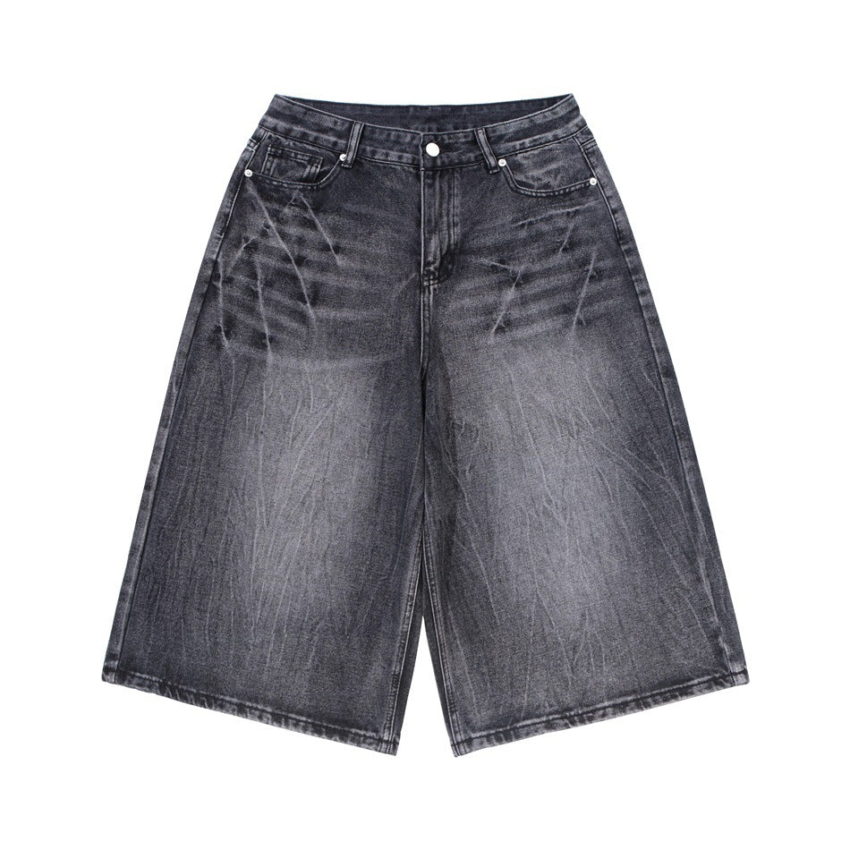 Washed black gray knee-length wide-leg denim shorts with faded creases, flat lay front view