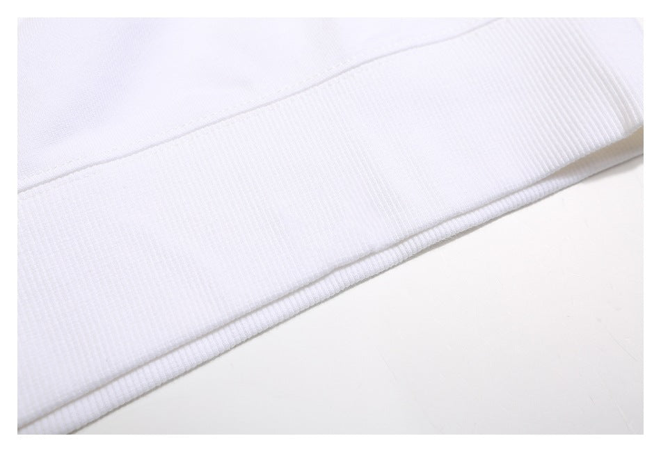 Close-up of the white sweatshirt's ribbed hem and adjoining seam.