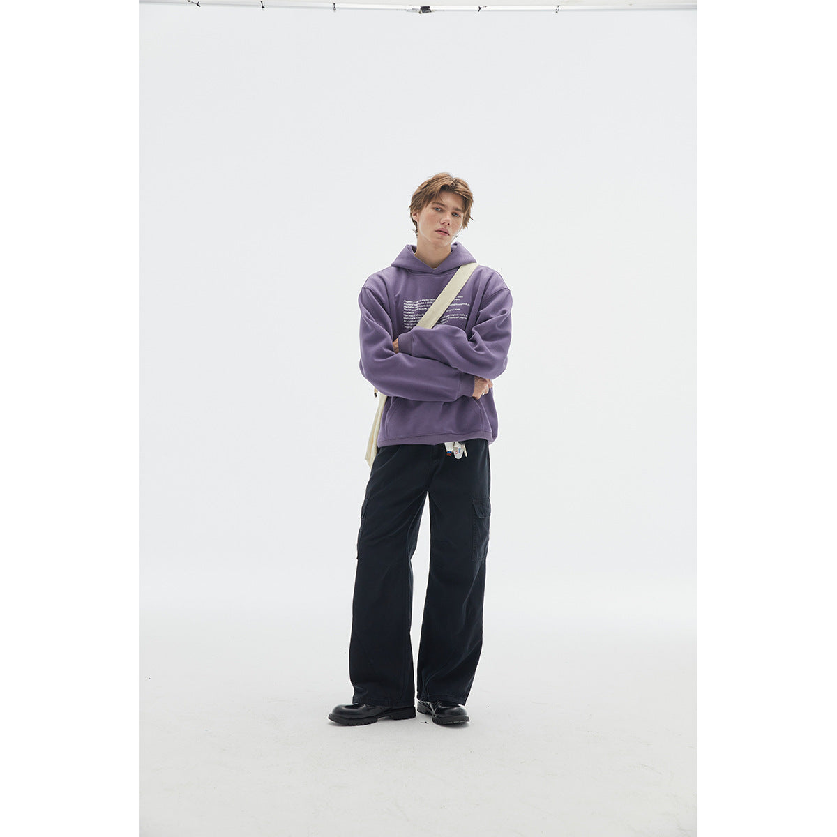 Model wearing a purple graphic hoodie, black wide-leg cargo pants, and black shoes.