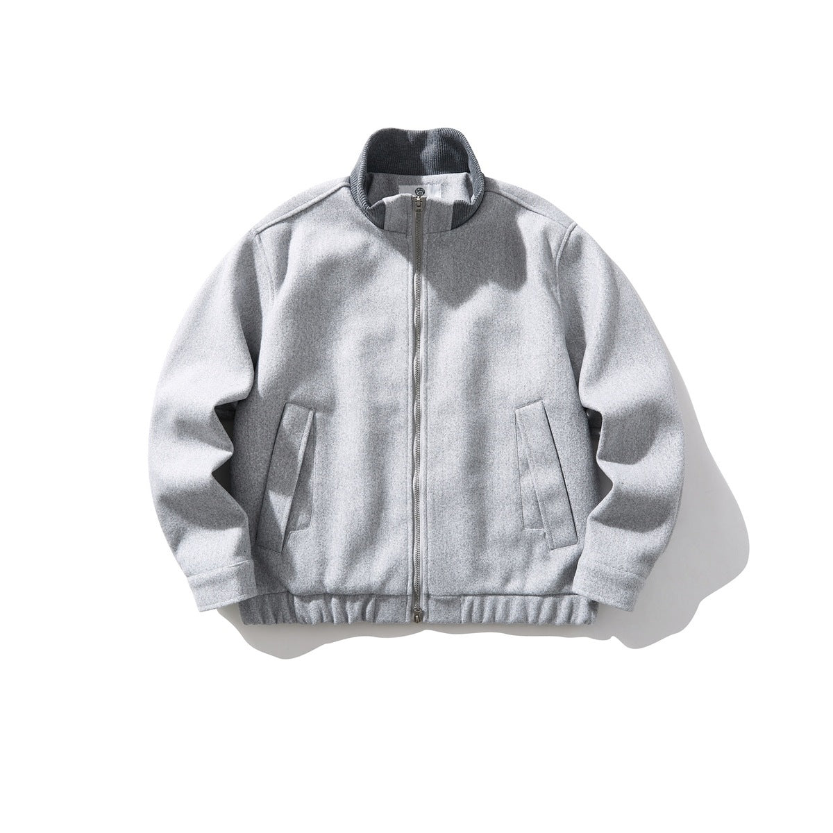 Light gray stand-collar zip jacket with ribbed collar, slanted pockets and elastic hem, flat lay