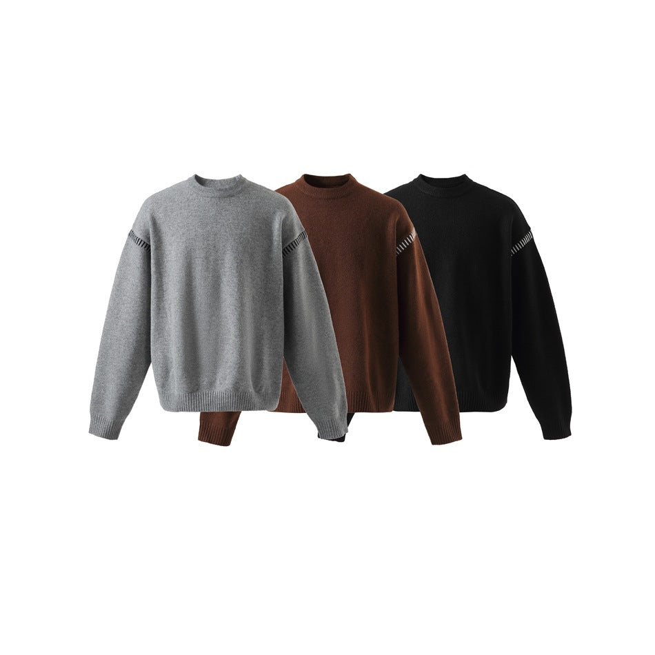 Three crew-neck sweaters shown from the front in gray, brown, and black, with white shoulder seam accents.