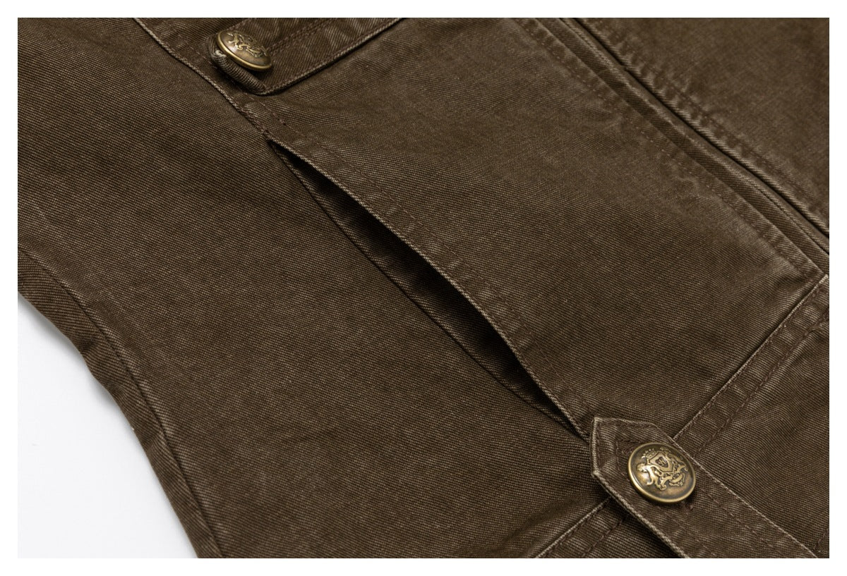 Close-up of a brown garment’s overlapping panels and side opening, finished with decorative brass-tone buttons.
