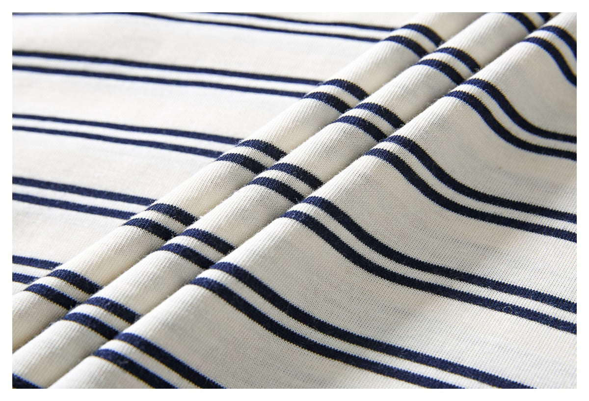 Close-up showing the ivory knit fabric and dark navy stripes of a garment.