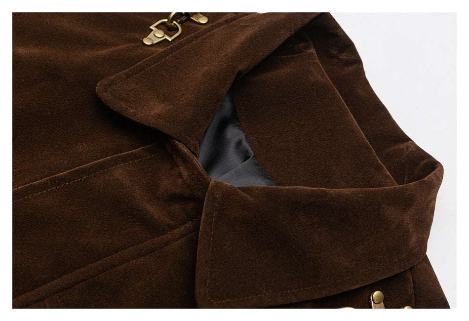 Close-up of the dark brown jacket's collar, layered fabric and brass shoulder hardware.