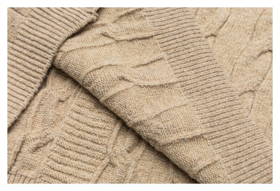 Close-up of beige cable-knit sweater fabric and a ribbed cuff.