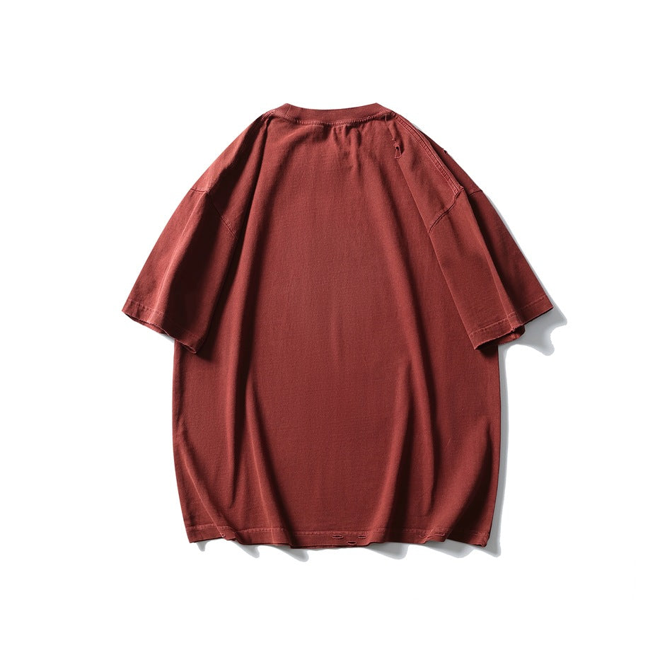 Back view of an oversized brick-red short-sleeve T-shirt with a crew neck and distressed hem details.