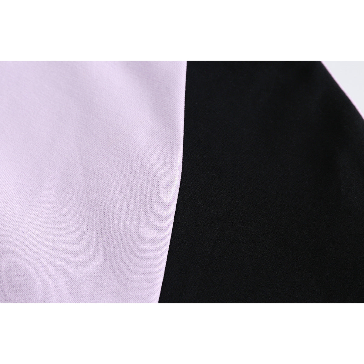 Fabric close-up showing lavender and black sections of the hoodie.