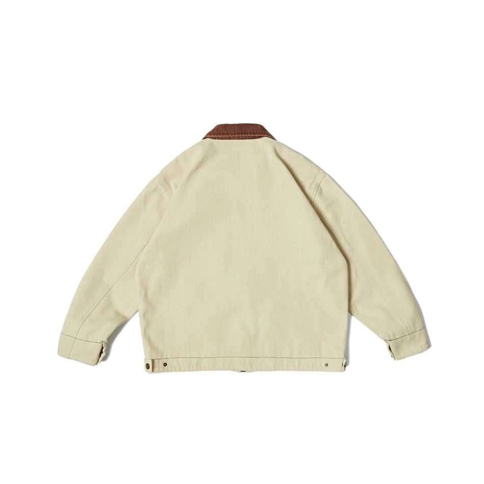 Back view of a light beige jacket with a contrasting brown collar and snap-adjustable hem.