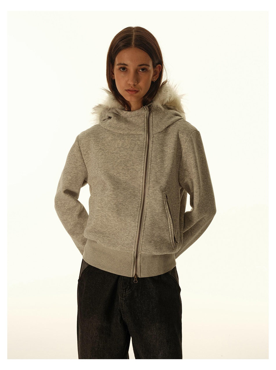 Front view of a model wearing a gray zip-up hoodie with a white faux-fur-trimmed hood and angled zip pockets.