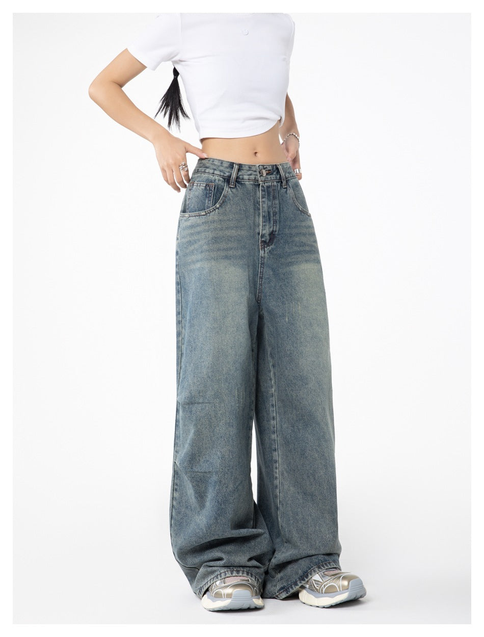 Front view of a model wearing faded blue, high-waisted jeans with very wide legs.