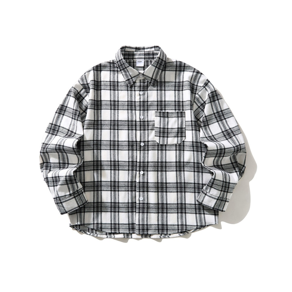 Black and white plaid long-sleeve button-up shirt with chest pocket, laid flat, front view