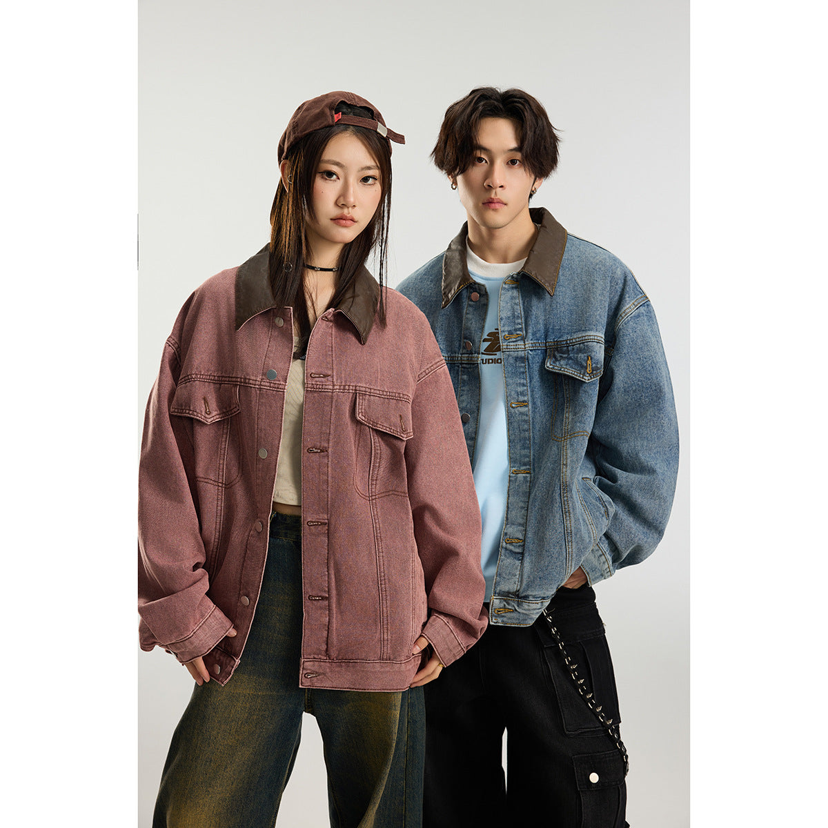 Two models wear oversized jackets: a dusty rose jacket with a dark collar and a blue denim jacket with a brown collar.