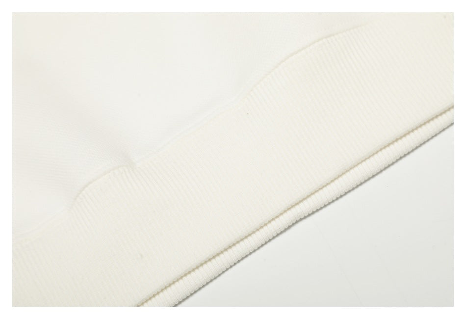 Close-up of a white garment's wide ribbed hem band.