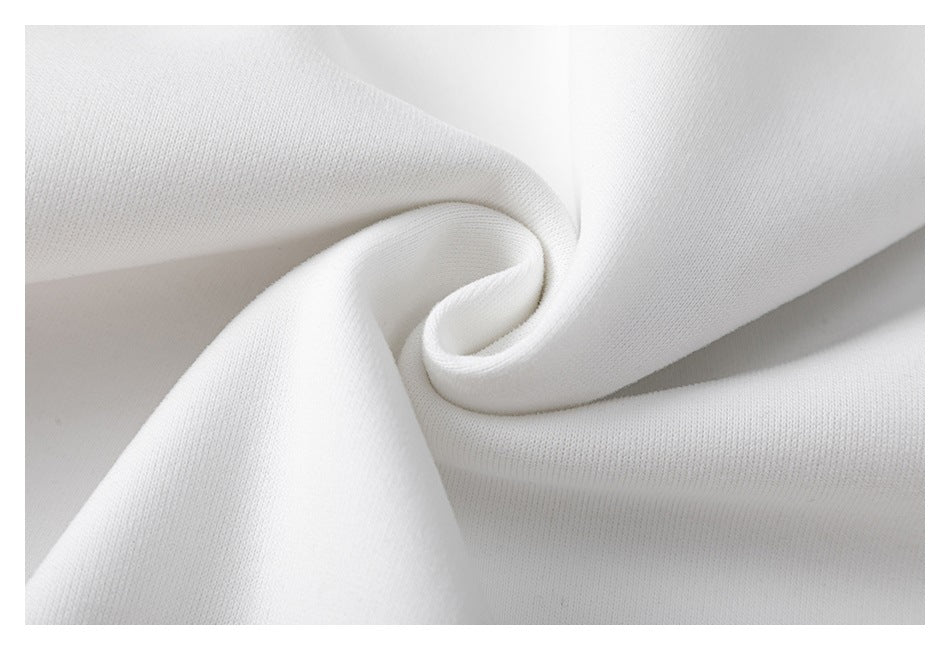 Close-up of softly folded white sweatshirt fabric showing its surface texture.