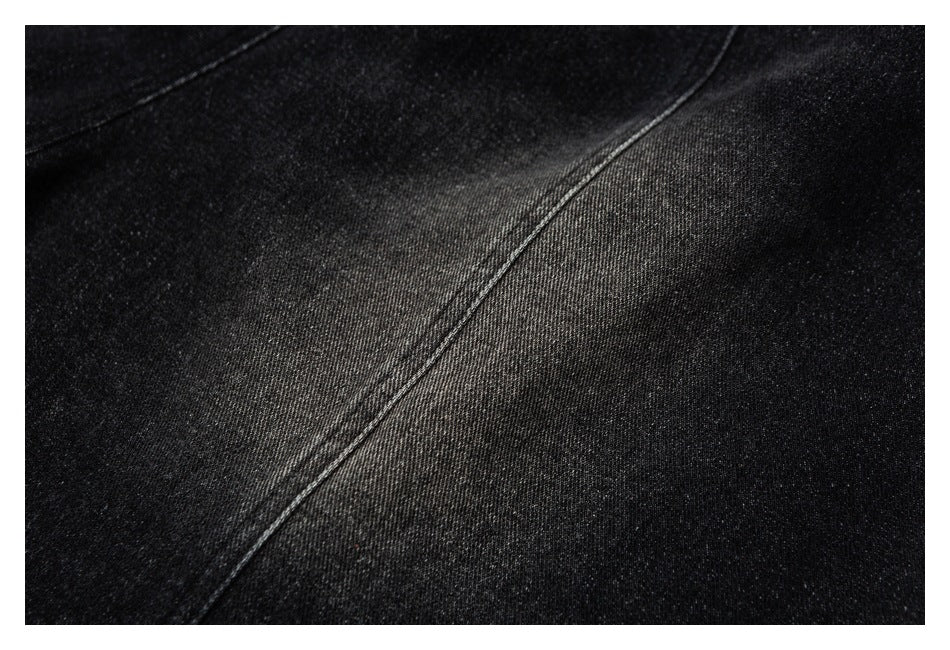 Close-up of black fabric with a diagonal stitched seam.