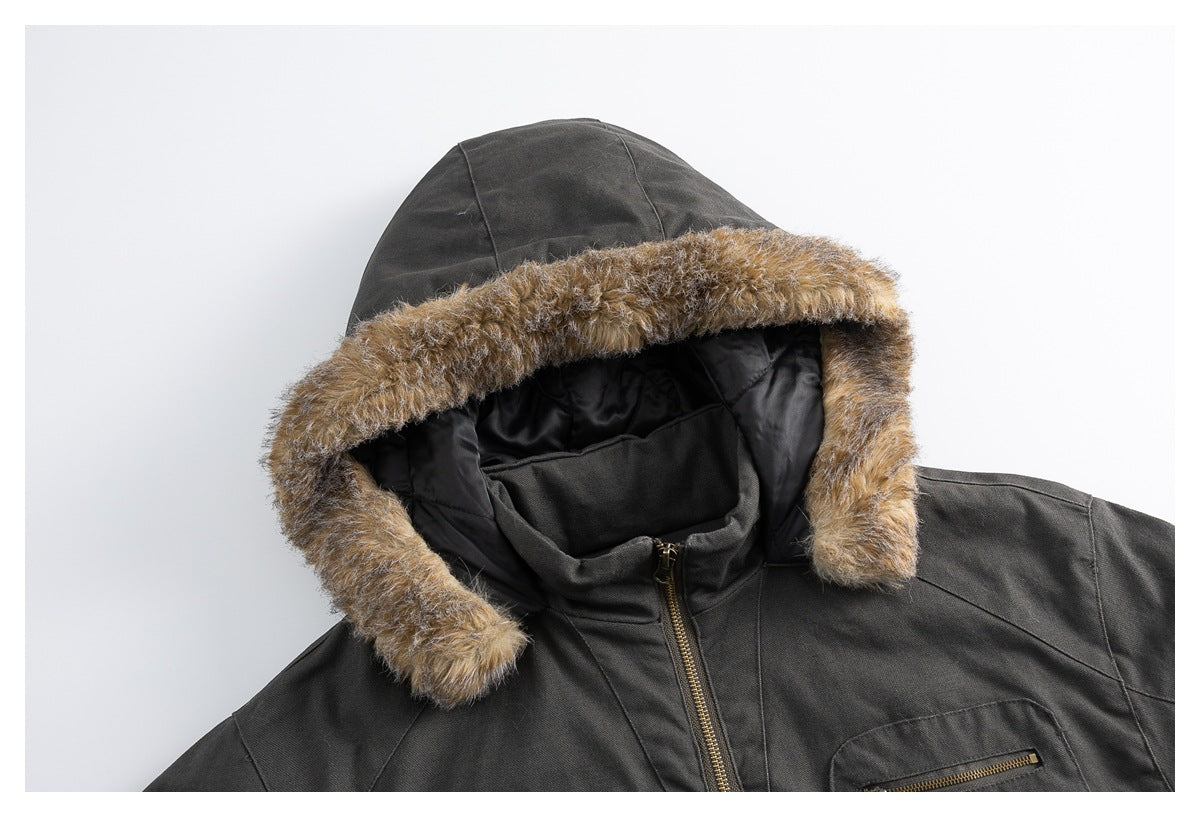 Close-up of a charcoal jacket hood with tan faux-fur trim, black lining, and a brass-tone zipper.