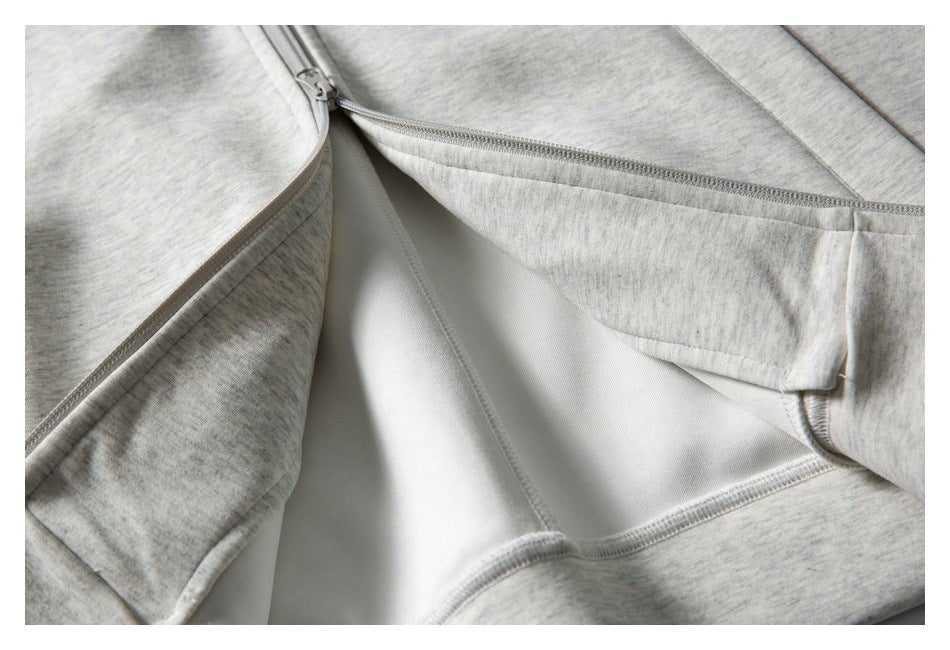 Close-up of a zipper and inner panel on the light gray marled sweatshirt.