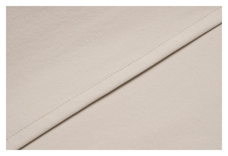 Close-up of a diagonal stitched seam on light beige fabric.