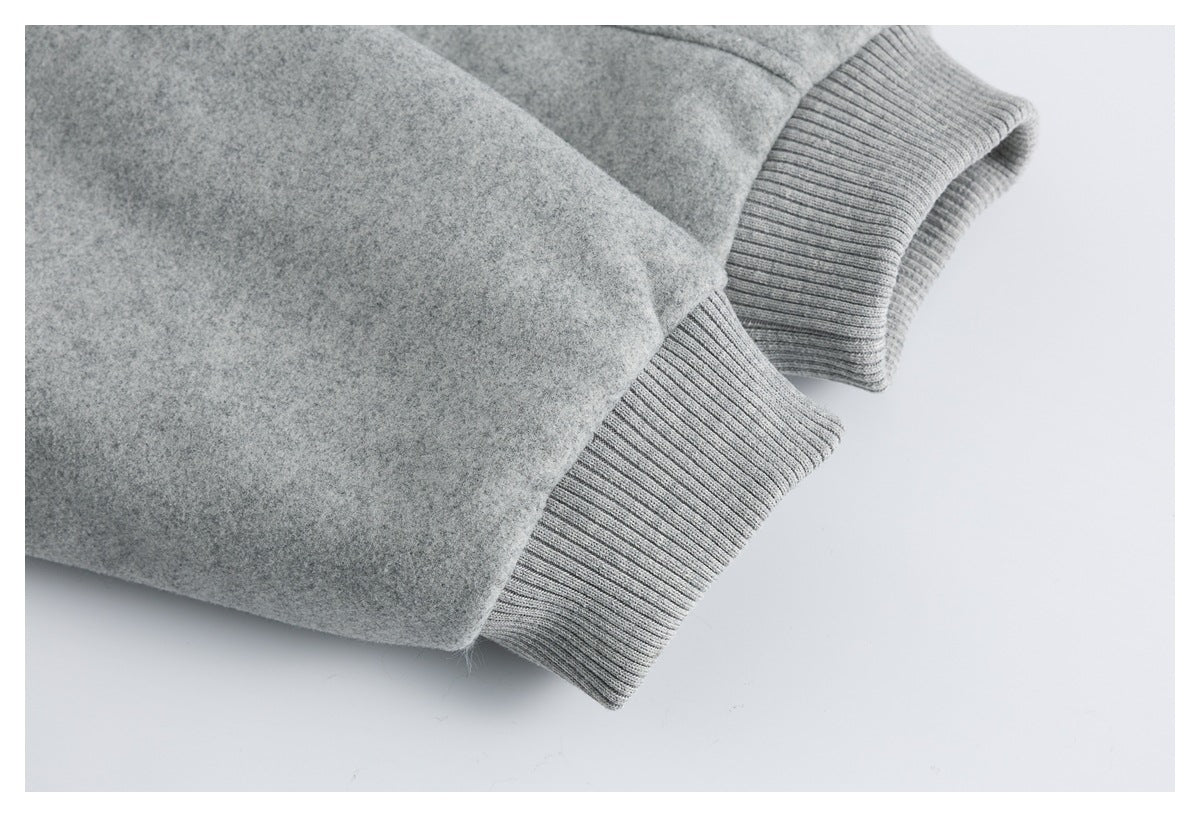 Close-up of a gray jacket sleeve ending in a wide ribbed cuff.