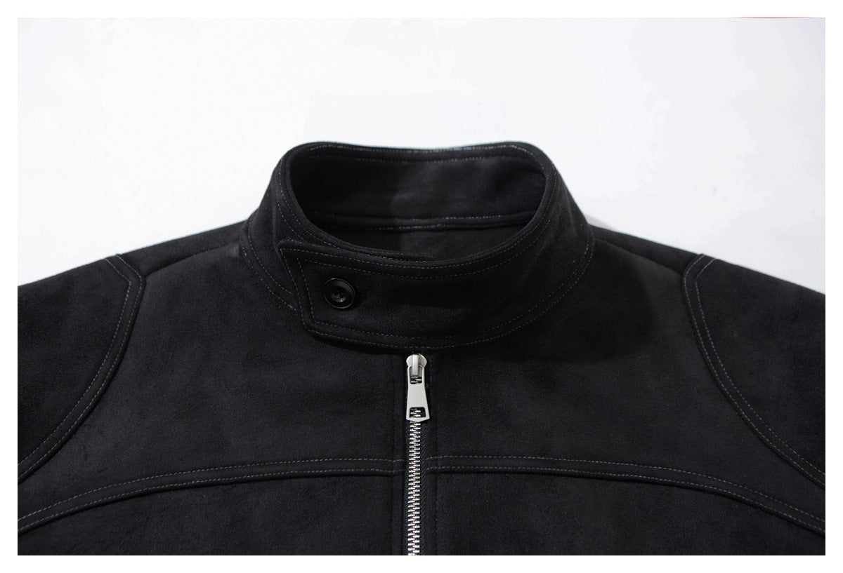 Close-up of a black jacket's stand collar, button, center zipper and curved stitching.