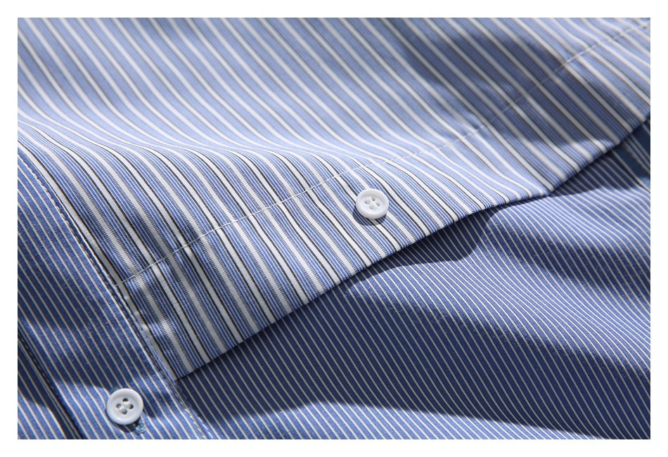 Close-up of a blue-and-white striped shirt placket with two white buttons.