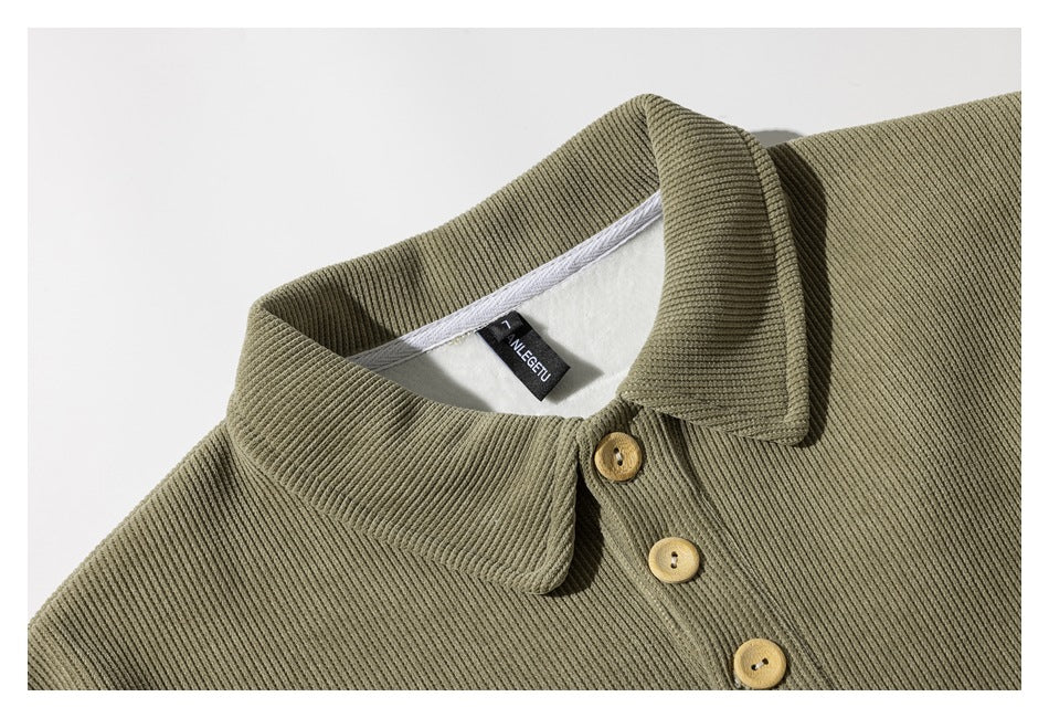 Close-up of an olive rib-knit collared top with three light wooden buttons and a small black neck label.