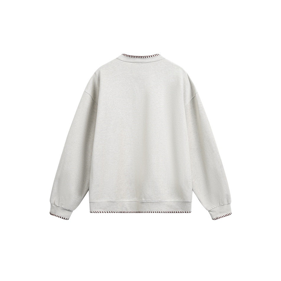 Back view of an ivory crewneck sweatshirt with brown contrast stitching at the collar, cuffs, and hem.