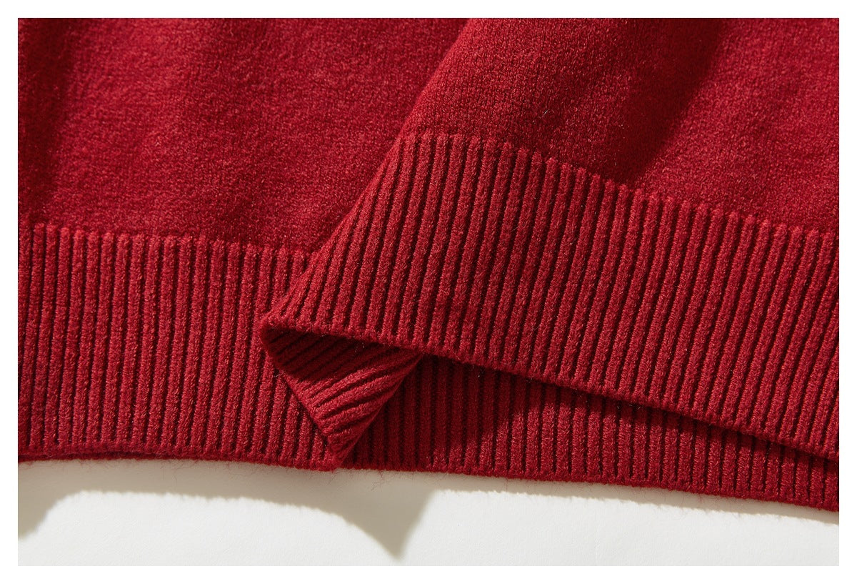 Close-up of the red sweater's ribbed lower hem and plain knit body.
