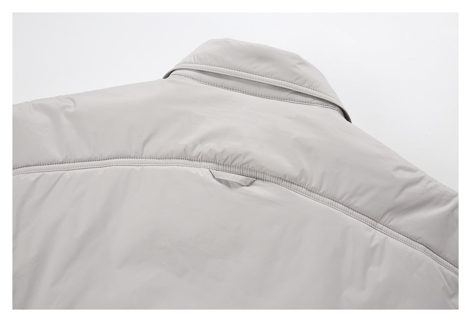 Close-up of the light gray jacket's back collar and curved stitched yoke.