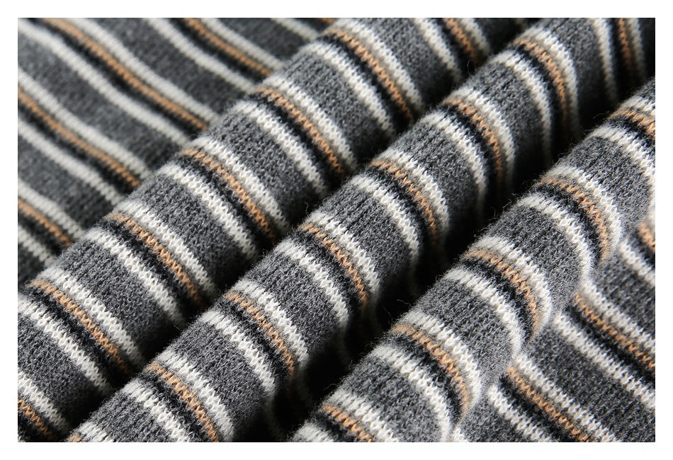 Macro view of the fuzzy gray knit texture and narrow cream and tan stripes.