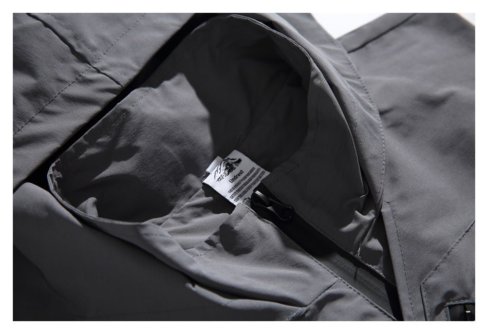 Close-up of the charcoal vest's inner collar, neck label, and front zipper.