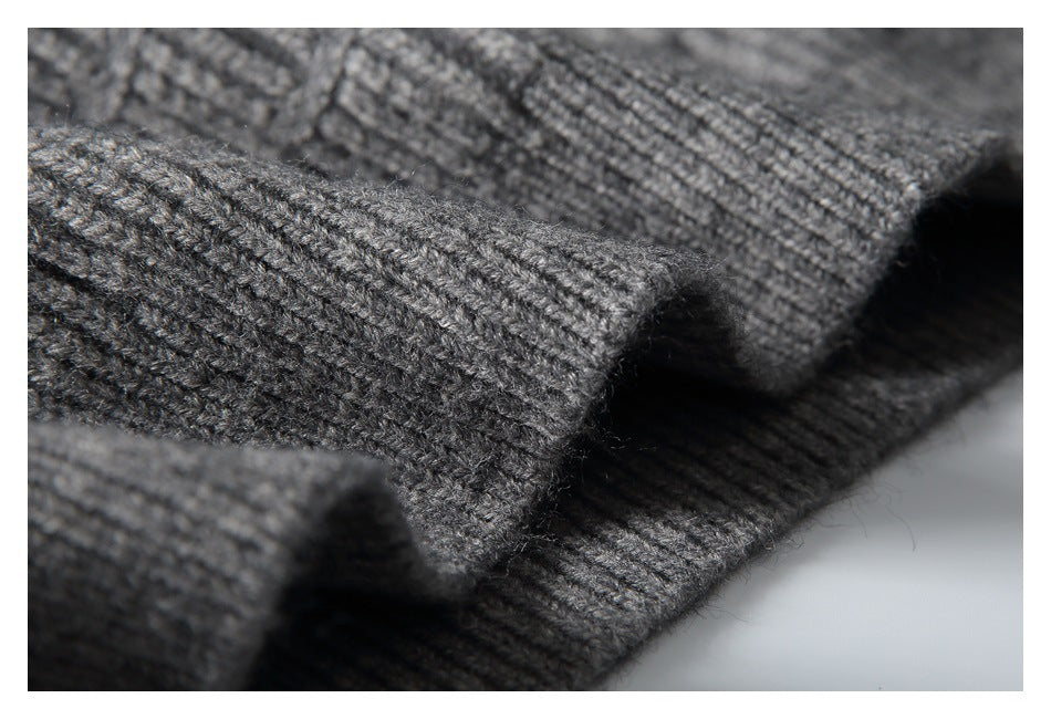 Close-up of a folded edge on a gray knit garment, showing ribbed stitching and fuzzy yarn texture.