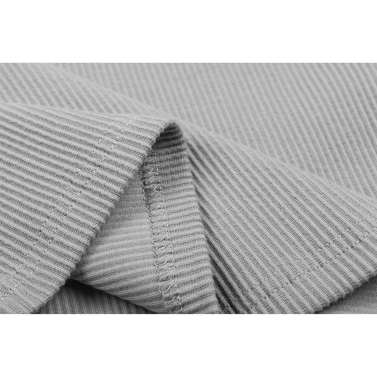 Close-up of ribbed fabric and stitched seam on the gray tank top.