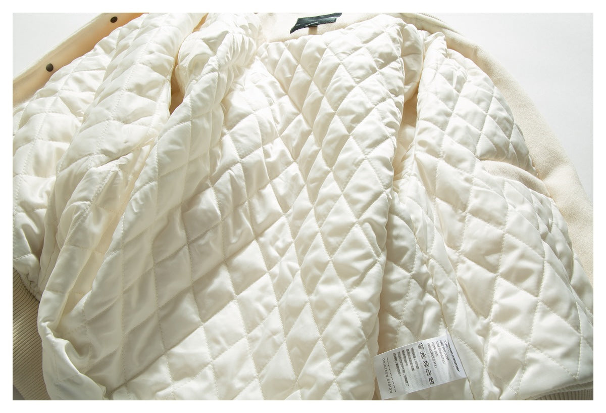 Close-up of the jacket's cream diamond-quilted lining and a care label.