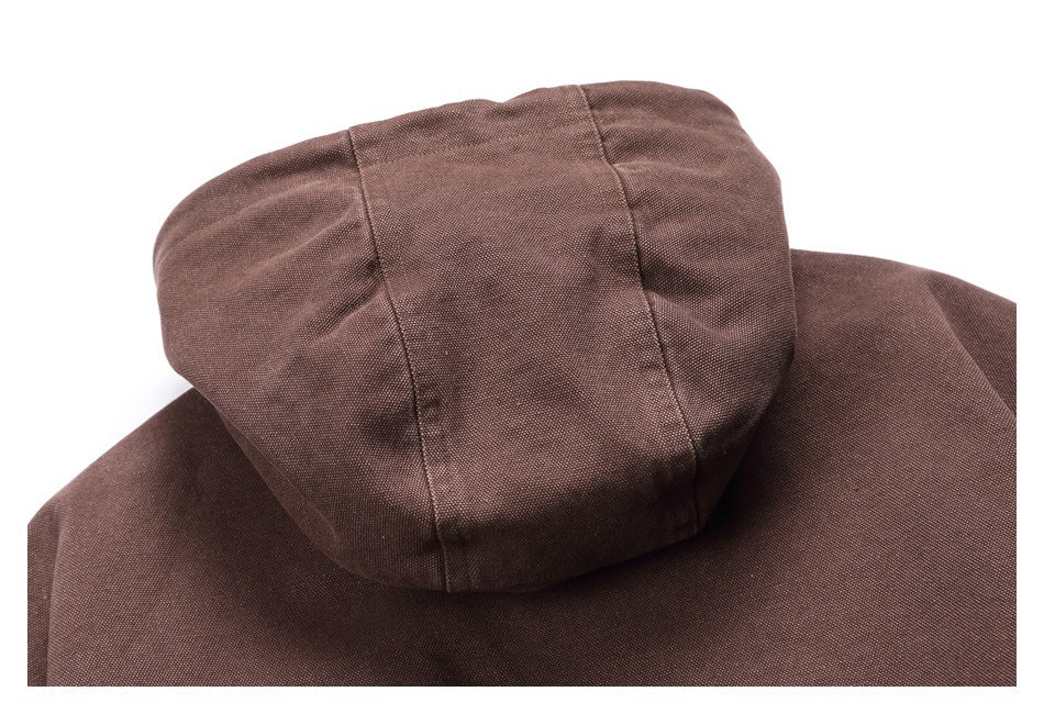 Close-up of a brown garment's hood, showing panel seams and textured fabric.